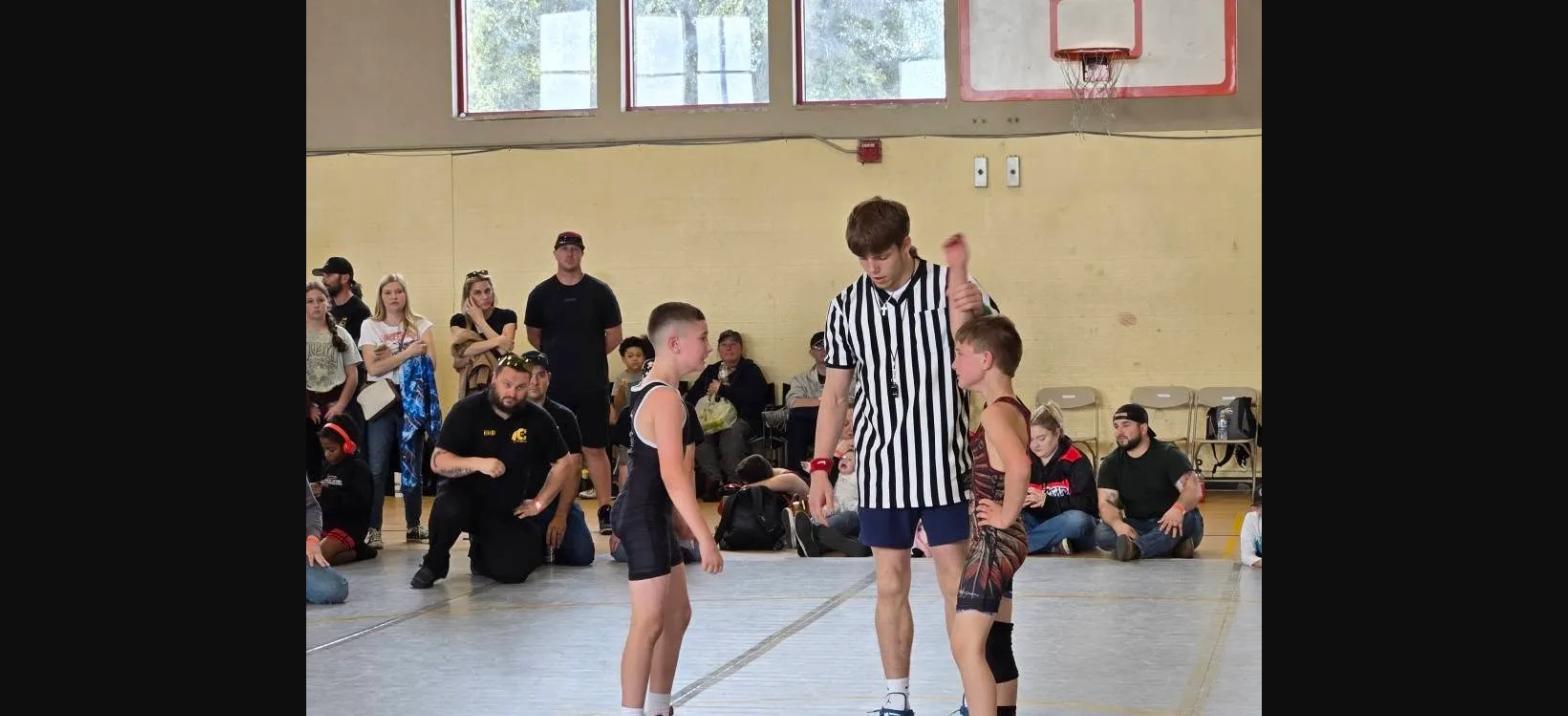 Referee raises the winner's hand